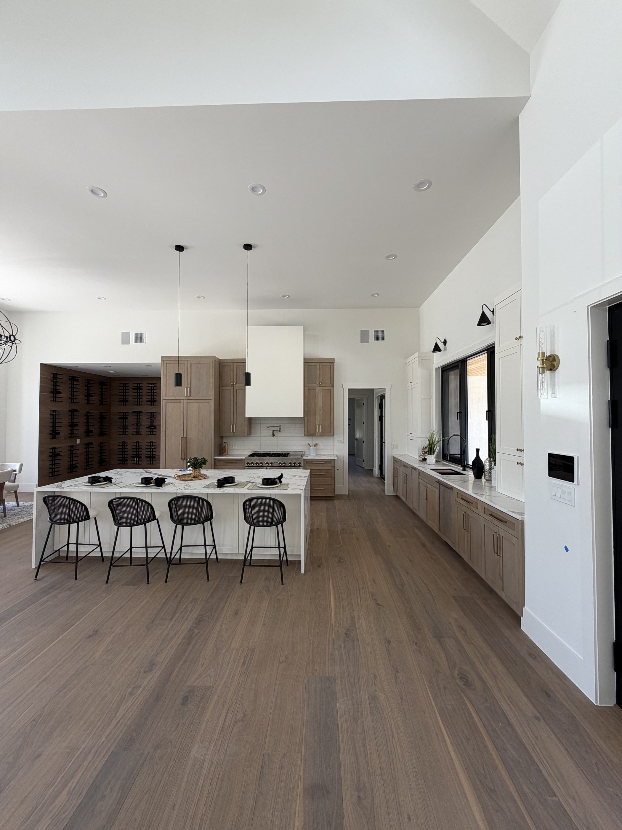Alder chef's kitchen with marble waterfall island and bar seating