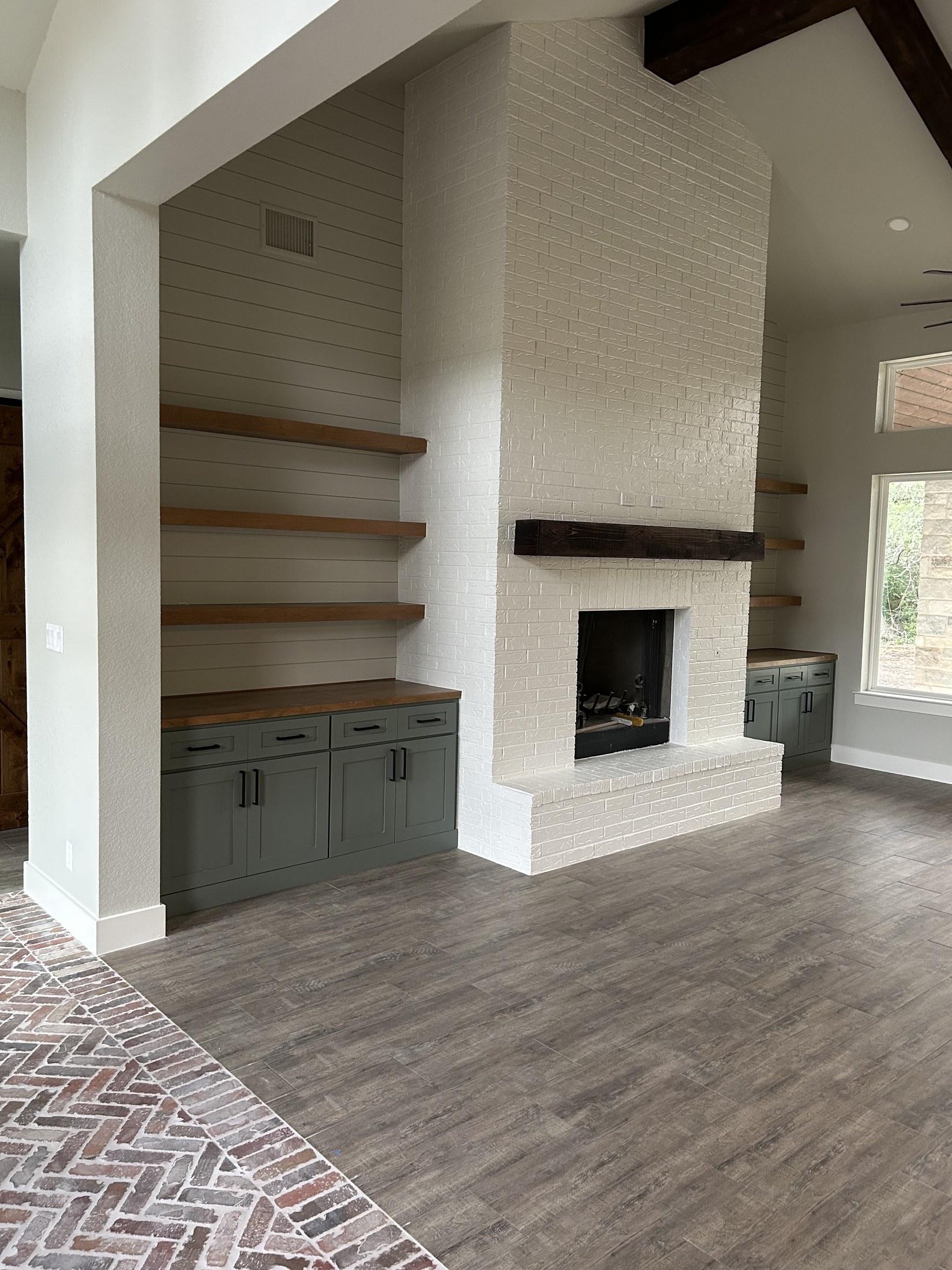 Living room with shiplap fireplace and floating shelves