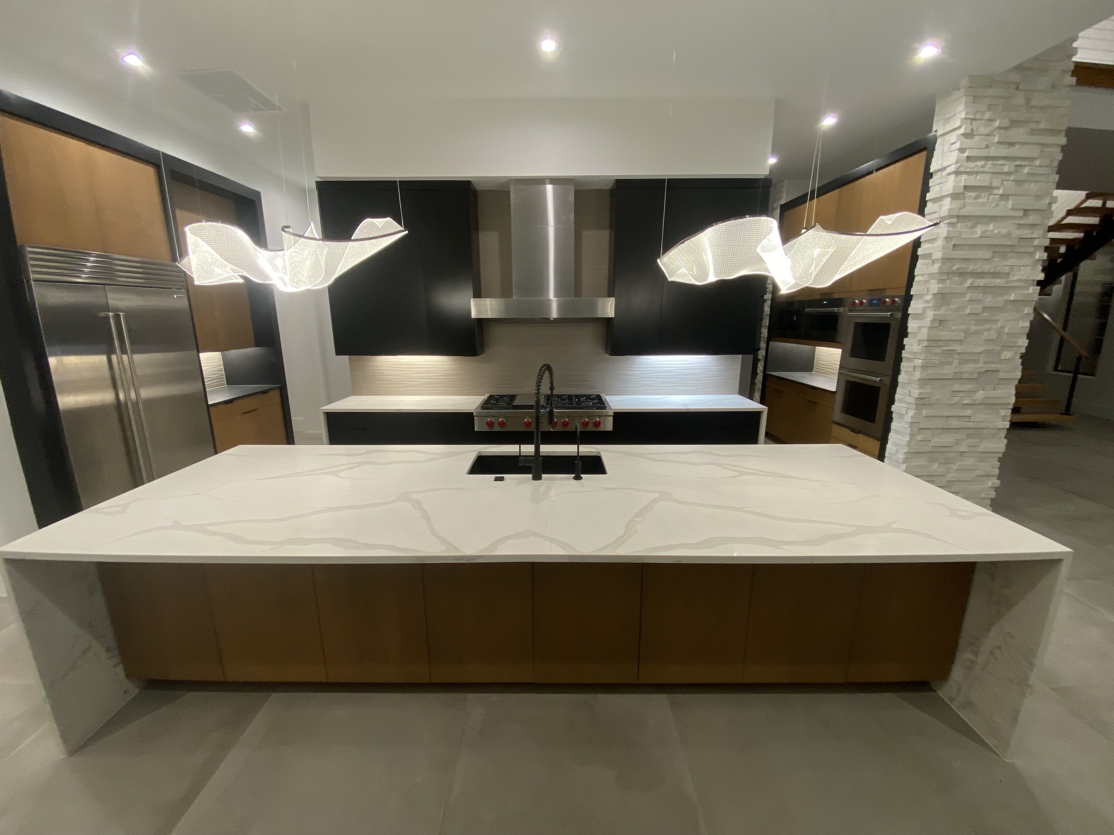 Modern kitchen with white oak island and marble waterfall