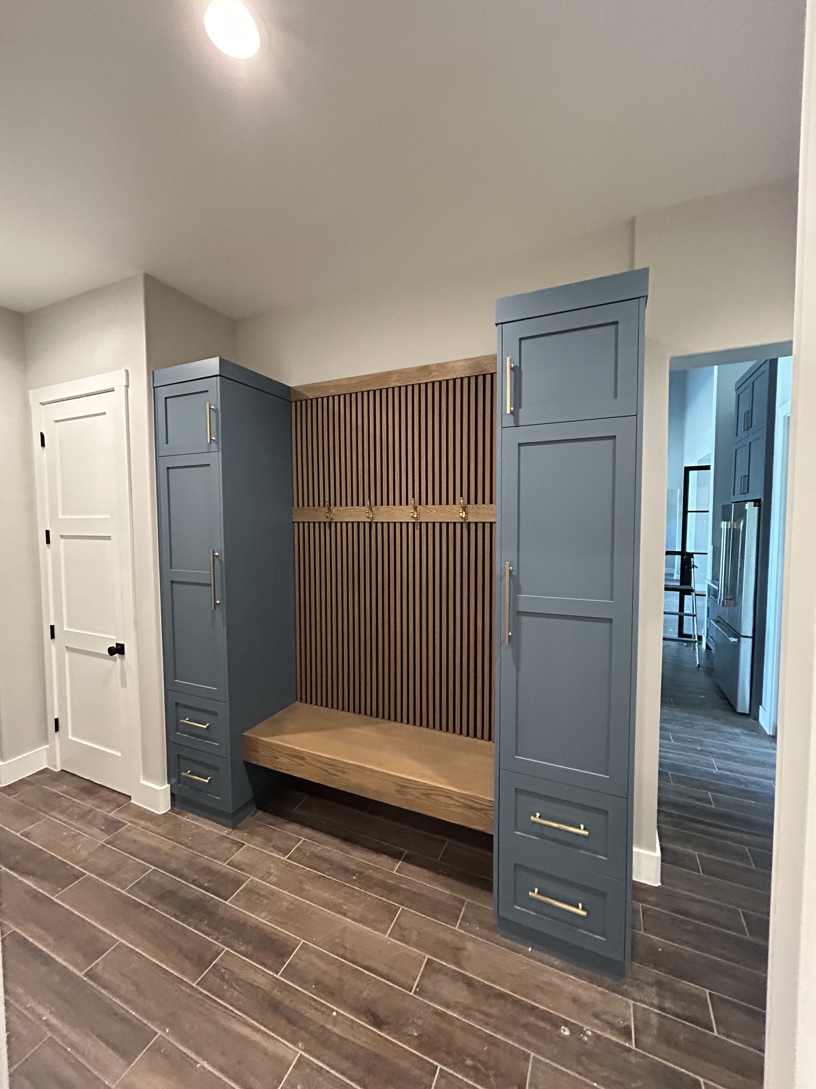Mudroom with locker cabinetry and fluted bench nook